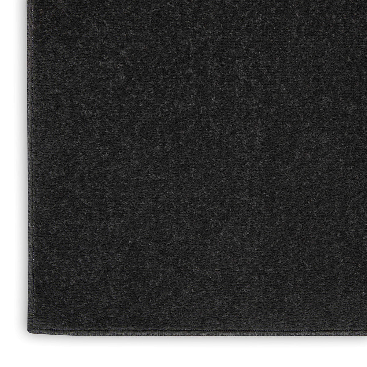Nourison Essentials Black 5' x Square rug as layering base for patterns.