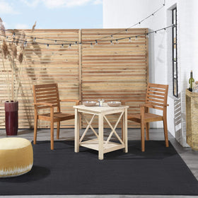 Nourison Essentials Black 5' x Square rug on patio, outdoor-ready durability.