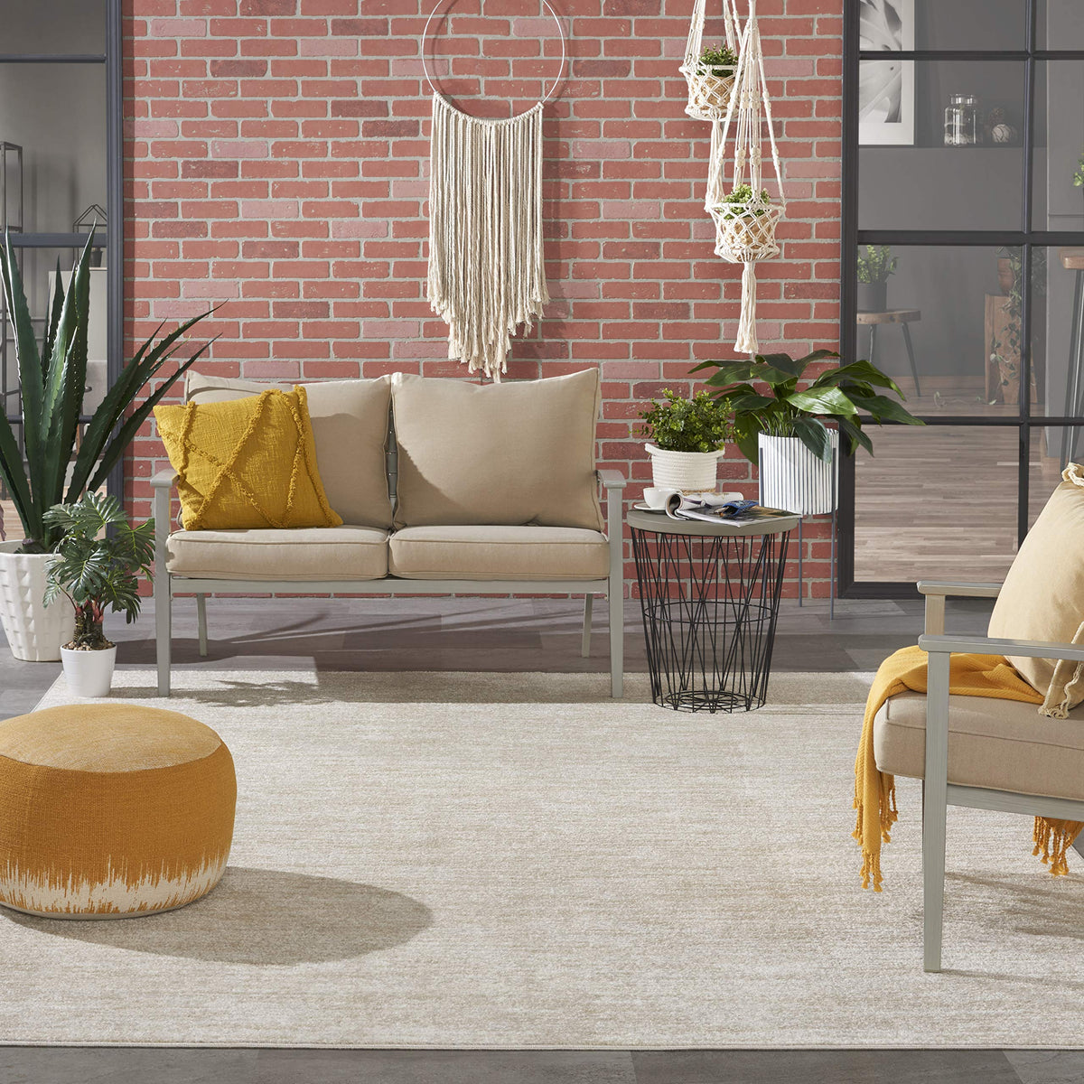 Nourison Essentials Ivory Beige outdoor porch scene demonstrates weather-ready, simple-clean maintenance.