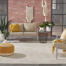 Nourison Essentials Ivory Beige outdoor porch scene demonstrates weather-ready, simple-clean maintenance.