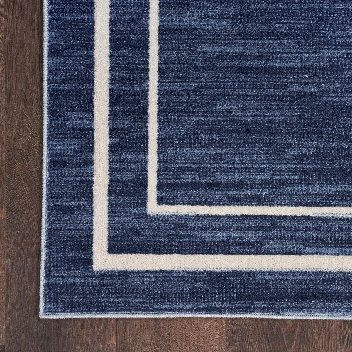 Nourison Essentials Navy/Ivory dining room scene pairs with tables for everyday meals.