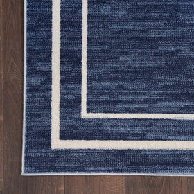 Nourison Essentials Navy/Ivory dining room scene pairs with tables for everyday meals.