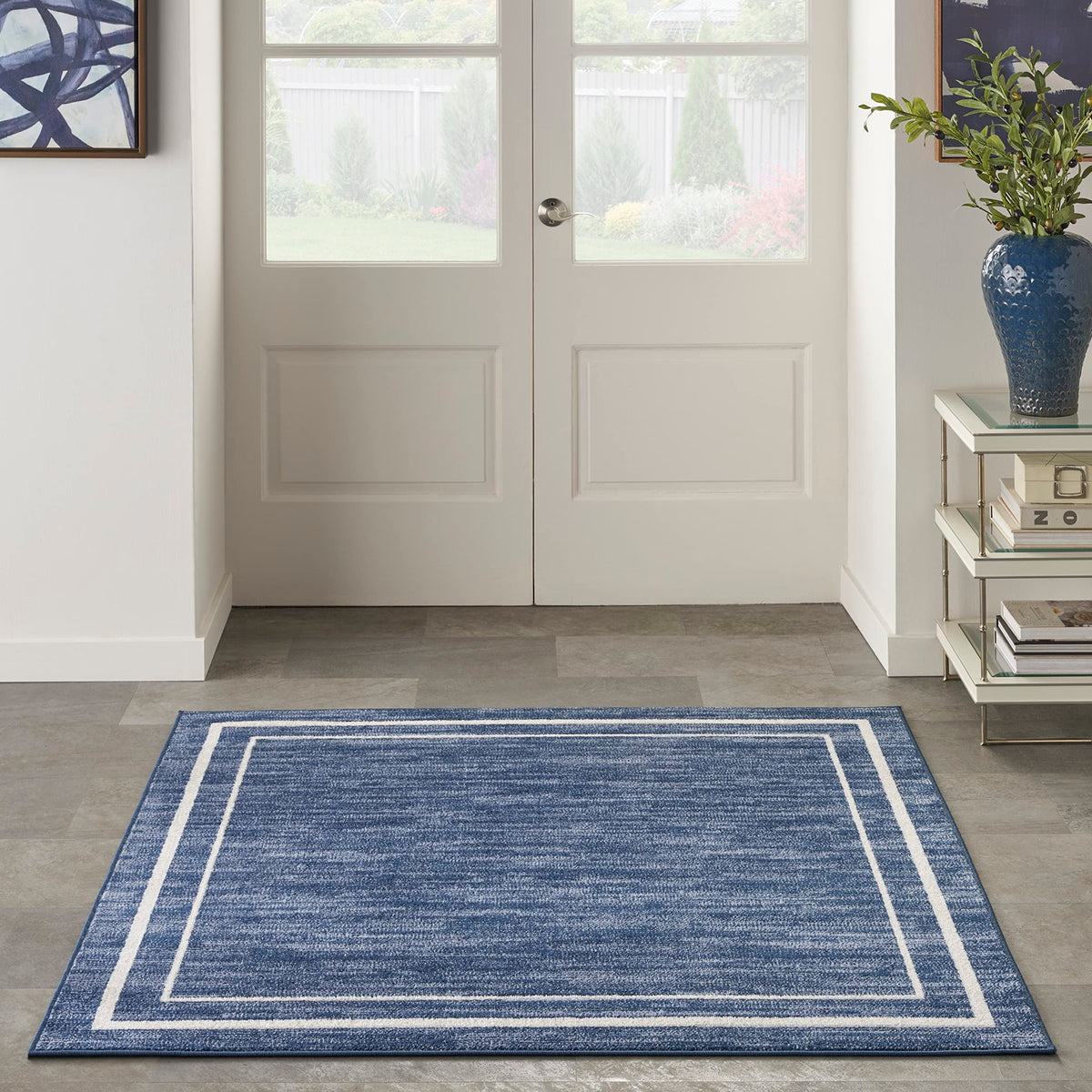 Nourison Essentials Navy/Ivory low-pile texture feels soft yet durable for high-traffic areas.