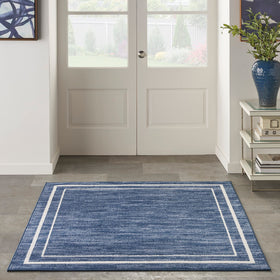 Nourison Essentials Navy/Ivory low-pile texture feels soft yet durable for high-traffic areas.