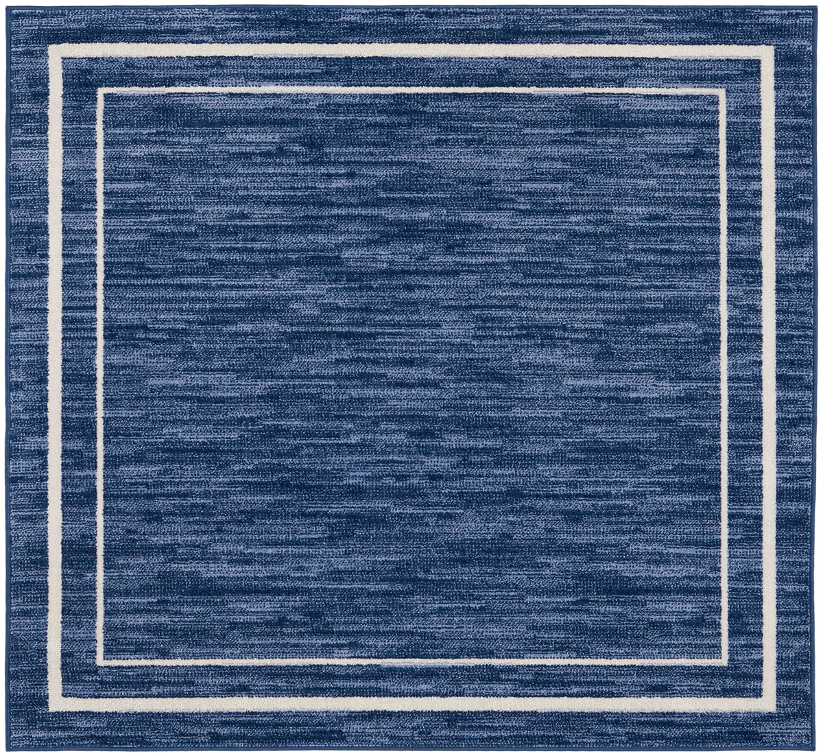 Nourison Essentials Navy/Ivory outdoor patio setup adds color and practical durability to a deck.