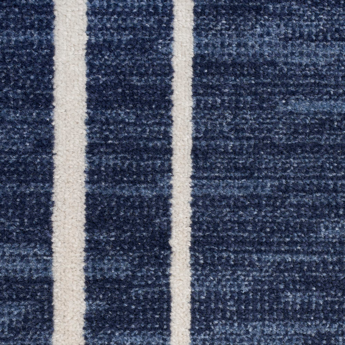 Nourison Essentials Navy/Ivory patio deck image demonstrates weather-friendly performance outdoors.