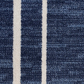 Nourison Essentials Navy/Ivory patio deck image demonstrates weather-friendly performance outdoors.