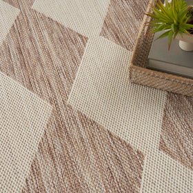 Nourison Positano beige rug complements dining room aesthetics with subtle pattern