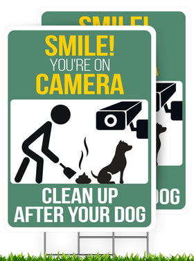 Nuah Prints clean up after your dog sign in the front yard with a stake for high visibility.