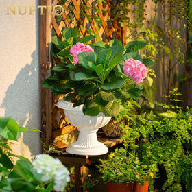 NUPTIO urn planter with wide opening for elaborate floral arrangements.