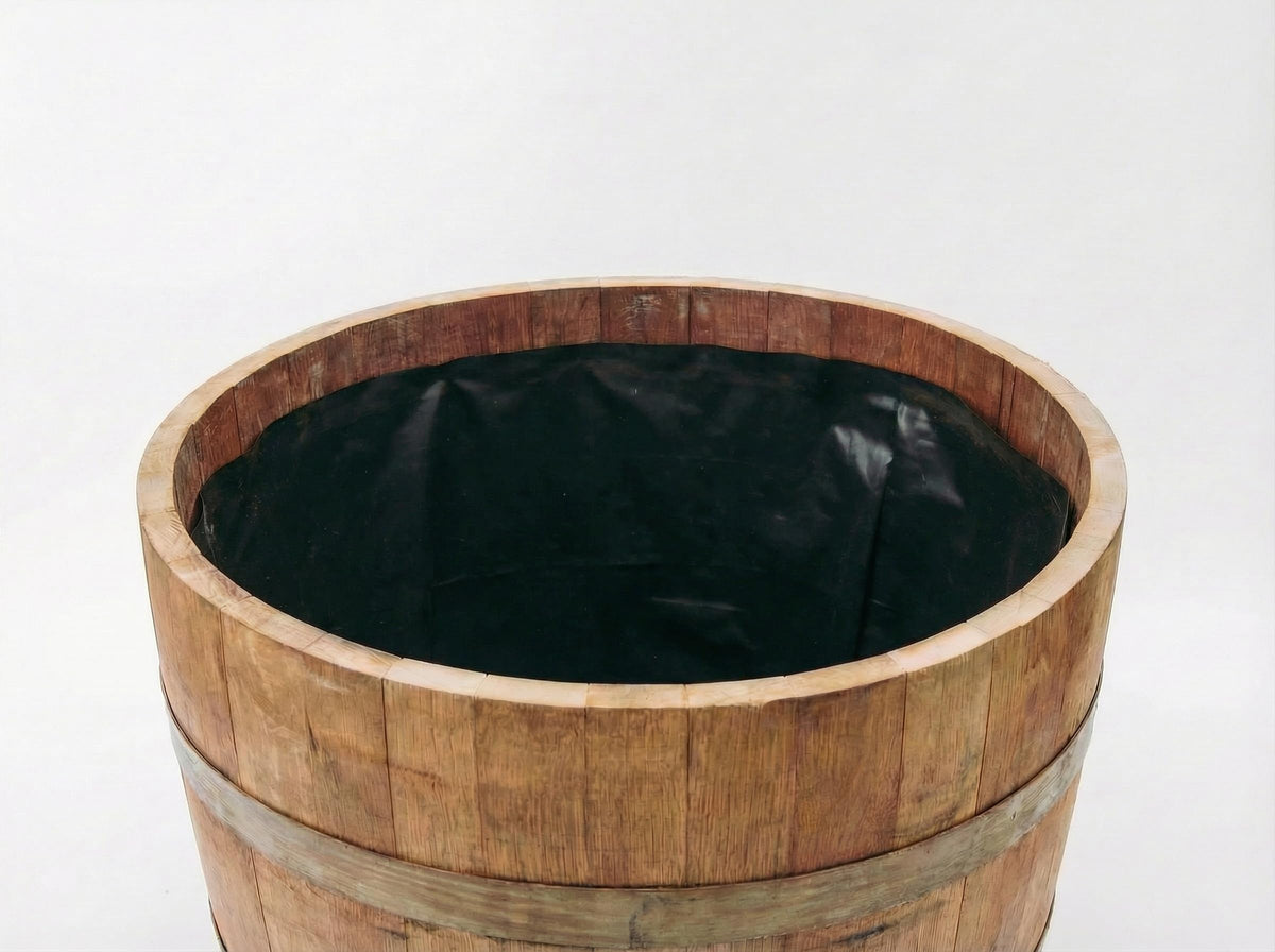 OAKENZ half-barrel liner in use protects wood from soil moisture.