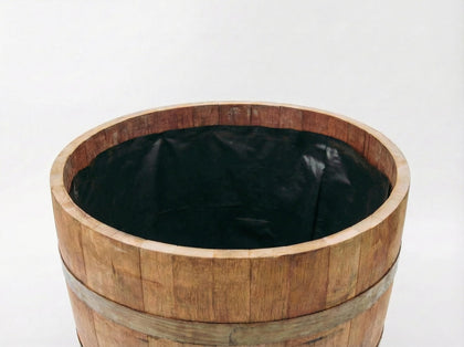 OAKENZ half-barrel liner in use protects wood from soil moisture.
