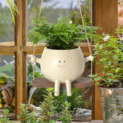 OLINLIFE smiley face planter swing adds playful charm to indoor or outdoor spaces.