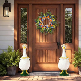 Straw hat adds seasonal flair to goose statues.