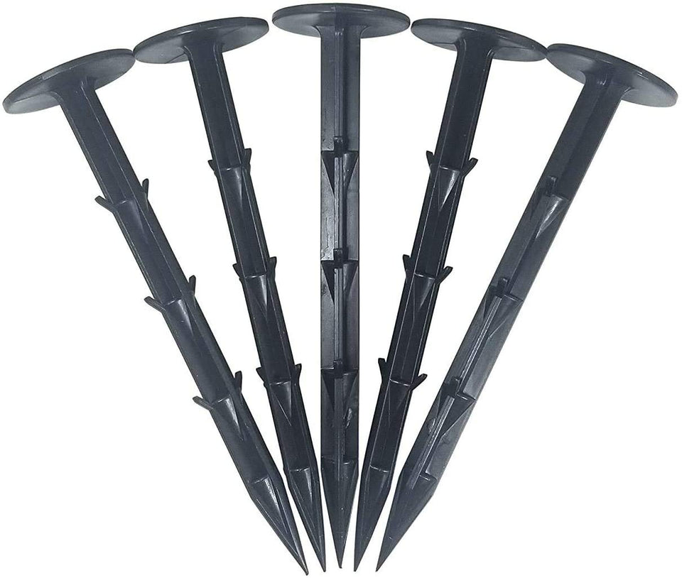 One Stop Outdoor 4in heavy-duty stake securing weed fabric for durable outdoor projects.