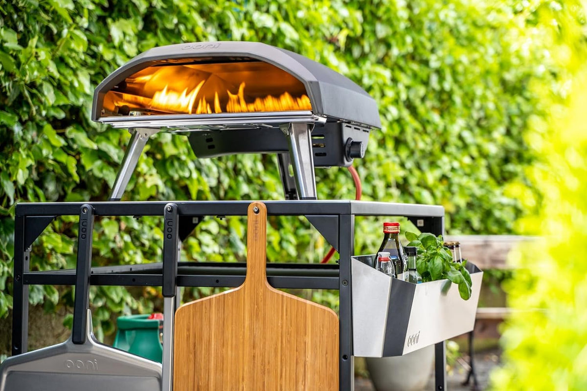 Ooni outdoor table built-in hooks for peels and accessories.