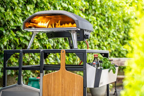 Ooni outdoor table built-in hooks for peels and accessories.