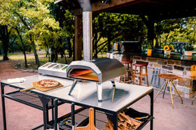 Ooni outdoor table locking casters enabling easy repositioning during gatherings.