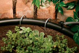 Orbit 67345 outdoor-use blank tubing in black blends with garden surroundings