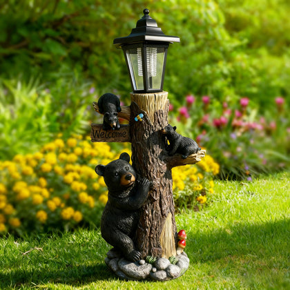 Oritty bear statue with welcome sign and solar lights enhances garden curb appeal