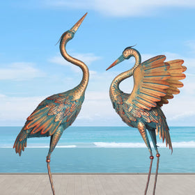 Oritty crane garden statue pair stands gracefully by the pond.