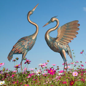 Oritty copper crane statue features hand-painted outdoor-safe finish.