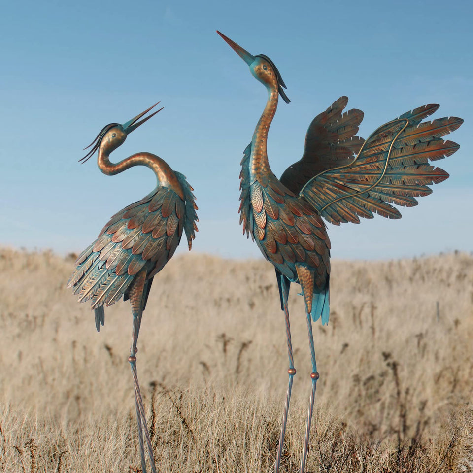 Oritty crane statues add elegant garden charm with copper finish for outdoor decor.