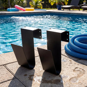 Otoolling wall-mounted hose hanger secures pool equipment off the ground.