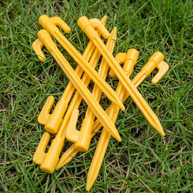 Oualhoo 25-pack yellow stakes laid out for landscape fabric and decor