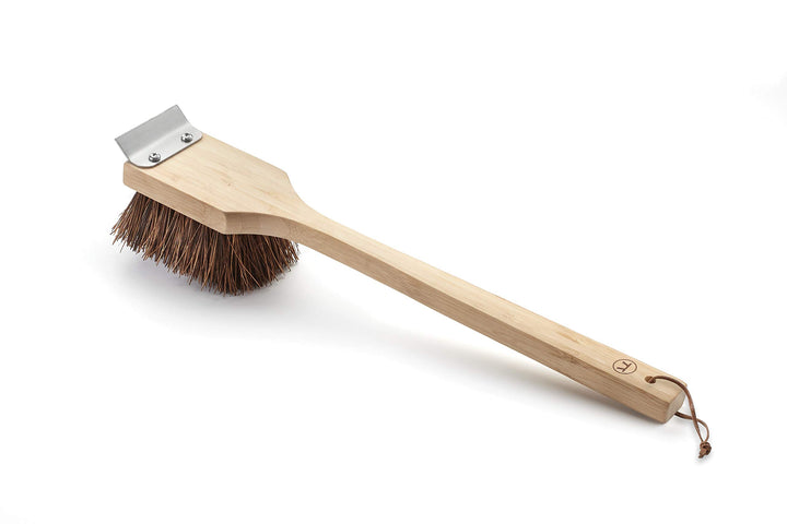 Outset grill cleaning brush with Palmyra bristles and wood handle for easy grill upkeep.