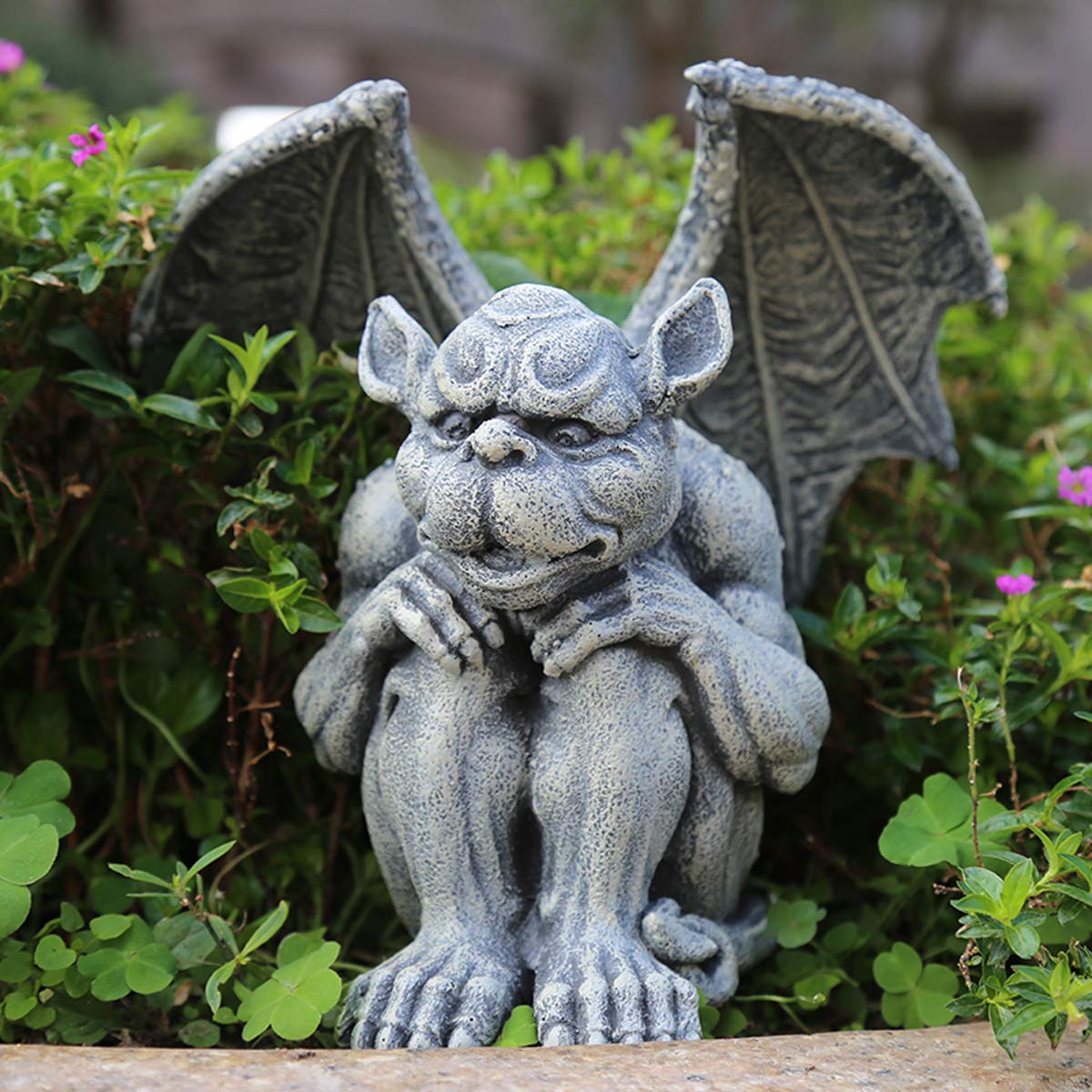 OwMell gargoyle statue guarding a garden with charming curb appeal.