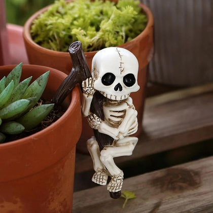 OwMell skeleton pot hugger gripping pot edge for playful Halloween decor.