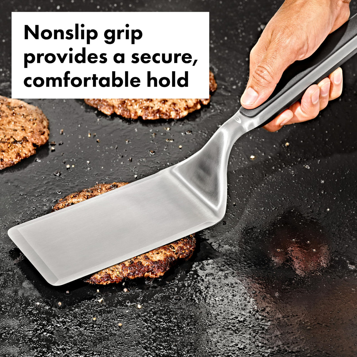 OXO Outdoor griddle turner showing non-slip handle for secure flipping