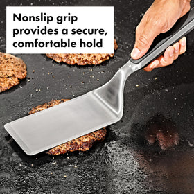 OXO Outdoor griddle turner showing non-slip handle for secure flipping