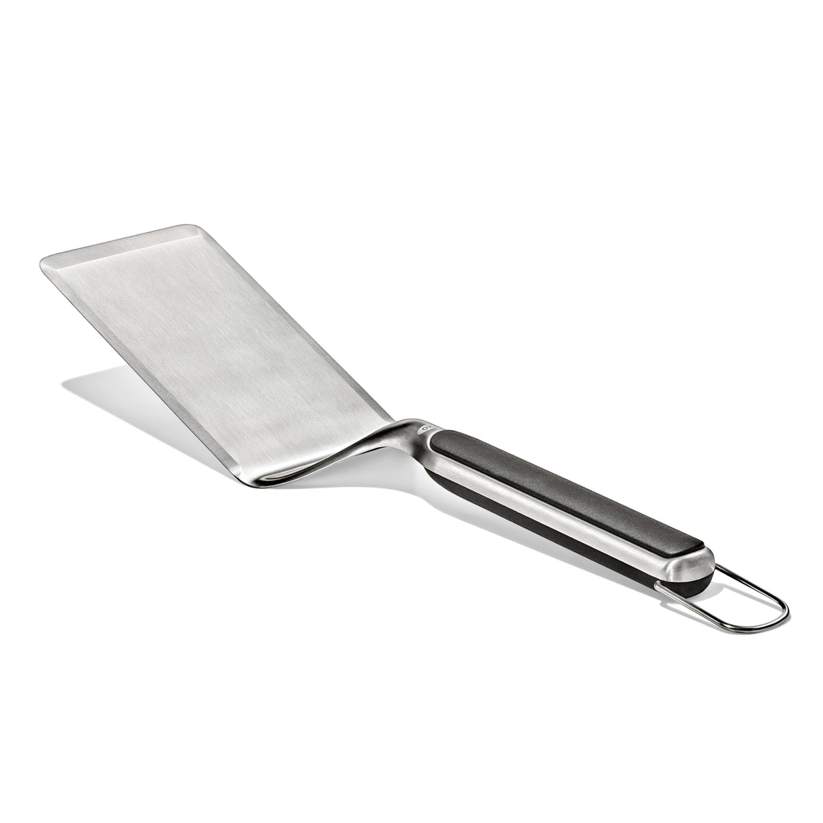 OXO Outdoor Large Griddle Turner in action flipping pancakes on a hot griddle