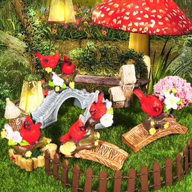 Four cardinal figurines on blossoms adding color to a display