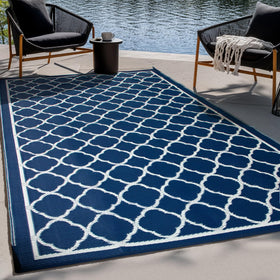 Pasamic outdoor rug 4x6ft laid on a patio, durable and easy to clean.
