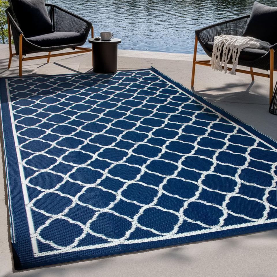 Pasamic outdoor rug 4x6ft laid on a patio, durable and easy to clean.