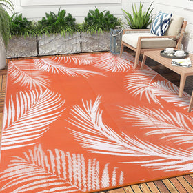 Pauwer leaf-orange rug adds soft, cozy underfoot for outdoor spaces.