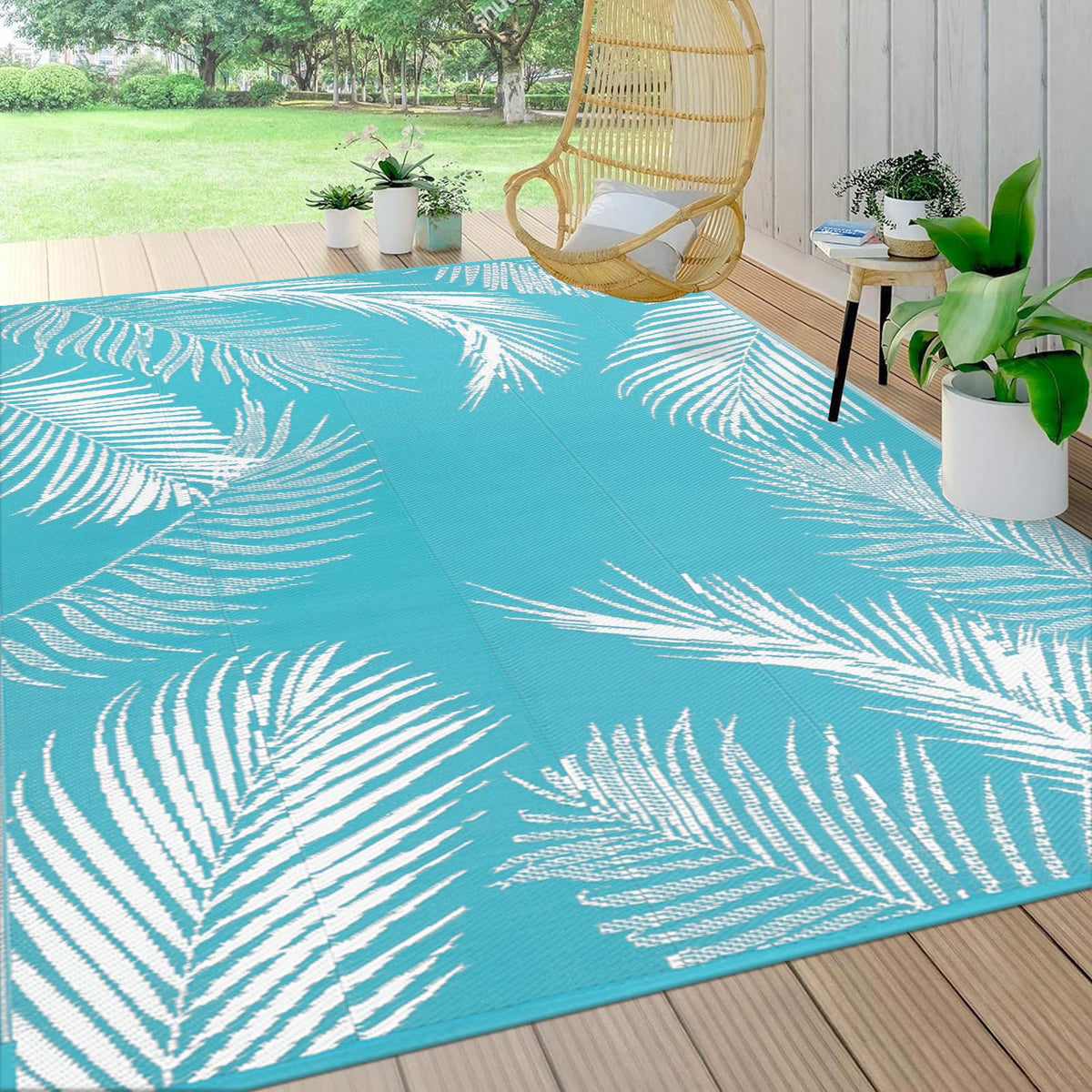 Pauwer leaf teal outdoor rug 8x10 for patio decor and weather-resistant durability.