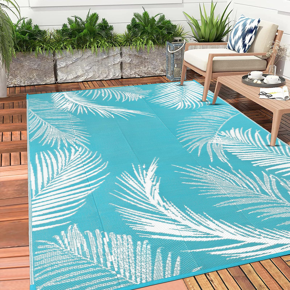 Pauwer outdoor teal leaf rug adding quick style to patio spaces.