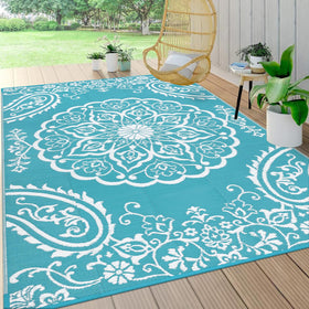 Pauwer reversible outdoor rug with floral pattern enhances patio decor.