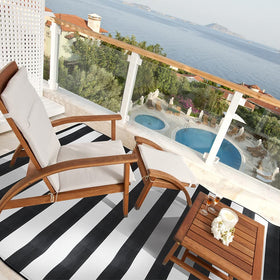 Pcinfuns reversible outdoor rug in black and white for versatile decor.