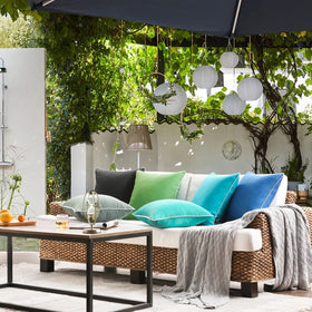 Indoor-outdoor versatility shown with Phantoscope forest green pillow cover.