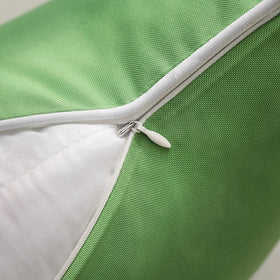 Forest green Phantoscope pillow cover displayed on patio for stylish outdoor decor.
