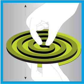 Lit PIC Coil emits a subtle scent while repelling mosquitoes at a table.