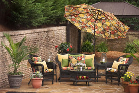 Pillow Perfect Tropic Floral outdoor lumbar pillow on black ground highlighting versatile indoor-outdoor decor.