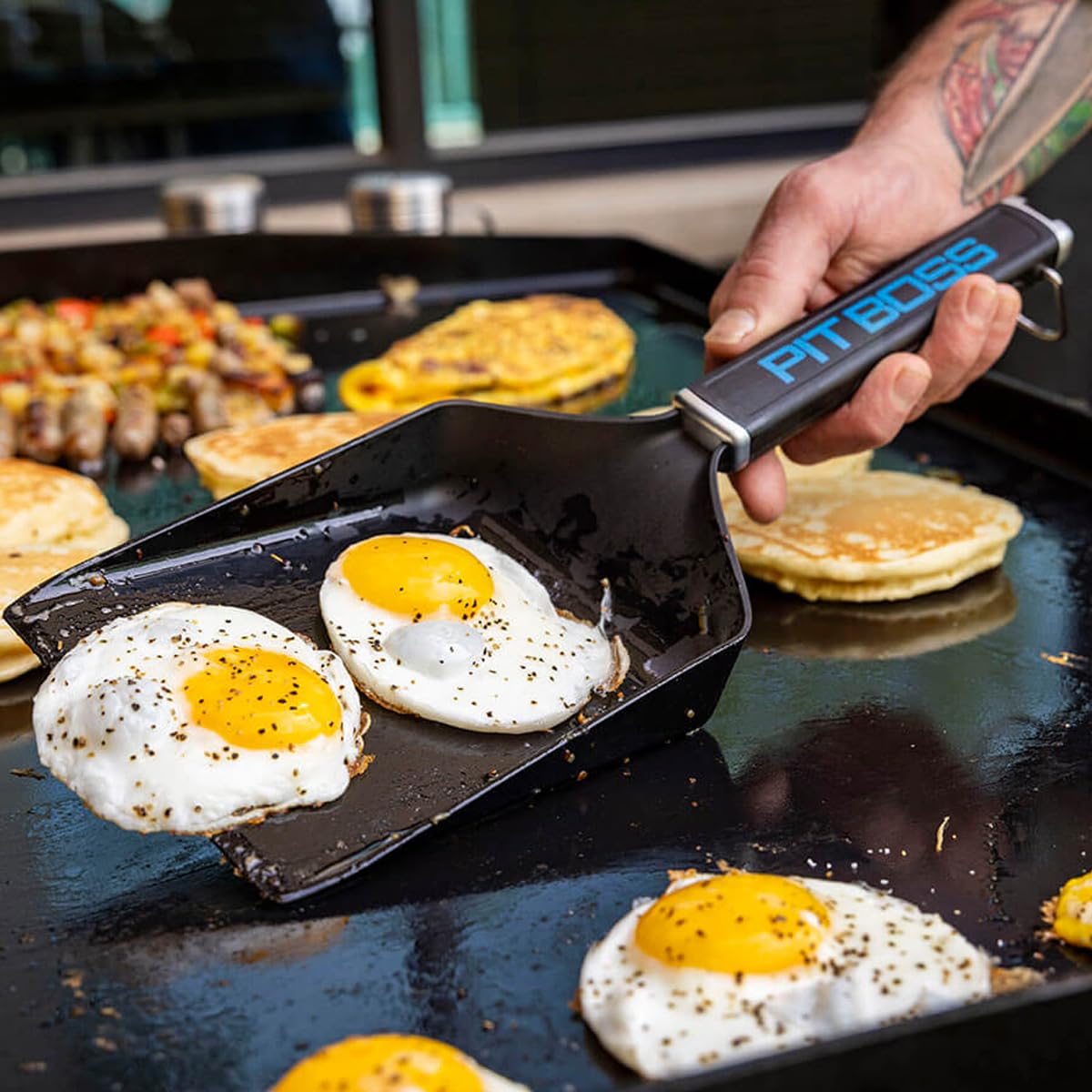 Pit Boss Ultimate Griddle Grub Shovel lifts hash browns smoothly for serving.