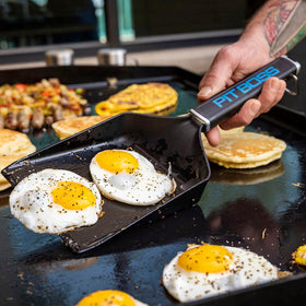 Pit Boss Ultimate Griddle Grub Shovel lifts hash browns smoothly for serving.