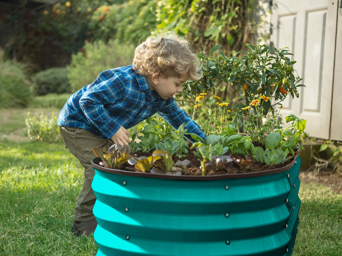 Plant & Plot turquoise open-base bed shown in a backyard garden.